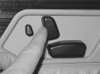 FIGURE 1.7. Good Mapping: Automobile Seat Adjustment Control. This is an excellent example of natural mapping. The control is in the shape of the seat itself: the mapping is straightforward. To move the front edge of the seat higher, lift up on the front part of the button. To make the seat back recline, move the button back. The same principle could be applied to much more common objects. This particular control is from Mercedes-Benz, but this form of mapping is now used by many automobile companies. (Photograph by the author.)