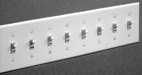 FIGURE 4.4. Incomprehensible Light Switches. Banks of switches like this are not uncommon in homes. There is no obvious mapping between the switches and the lights being controlled. I once had a similar panel in my home, although with only six switches. Even after years of living in the house, I could never remember which to use, so I simply put all the switches either up (on) or down (off). How did I solve the problem? See Figure 4.5.